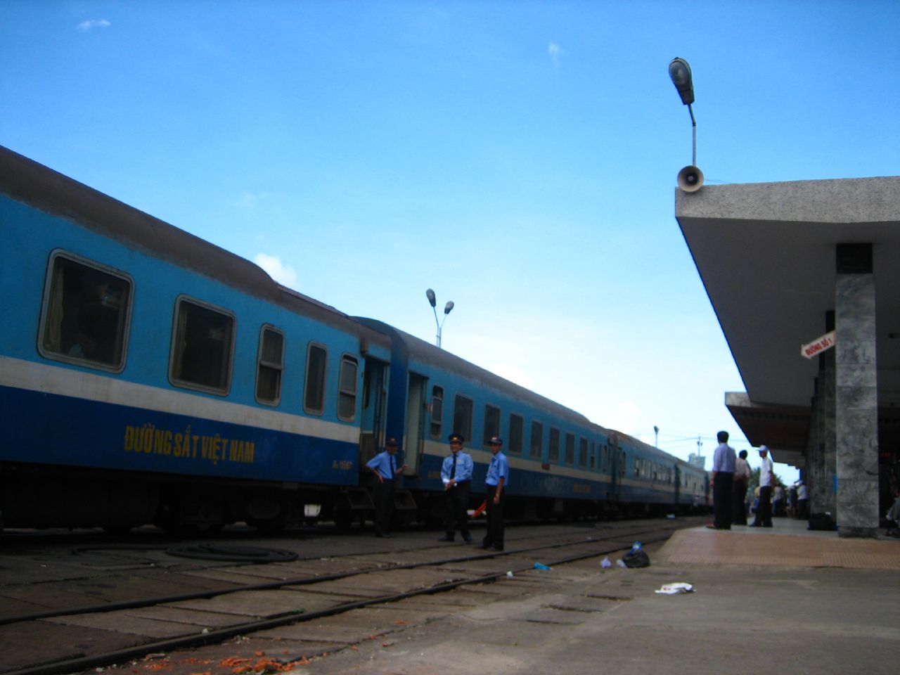 A blue Vietnam Railways train standing at a platform